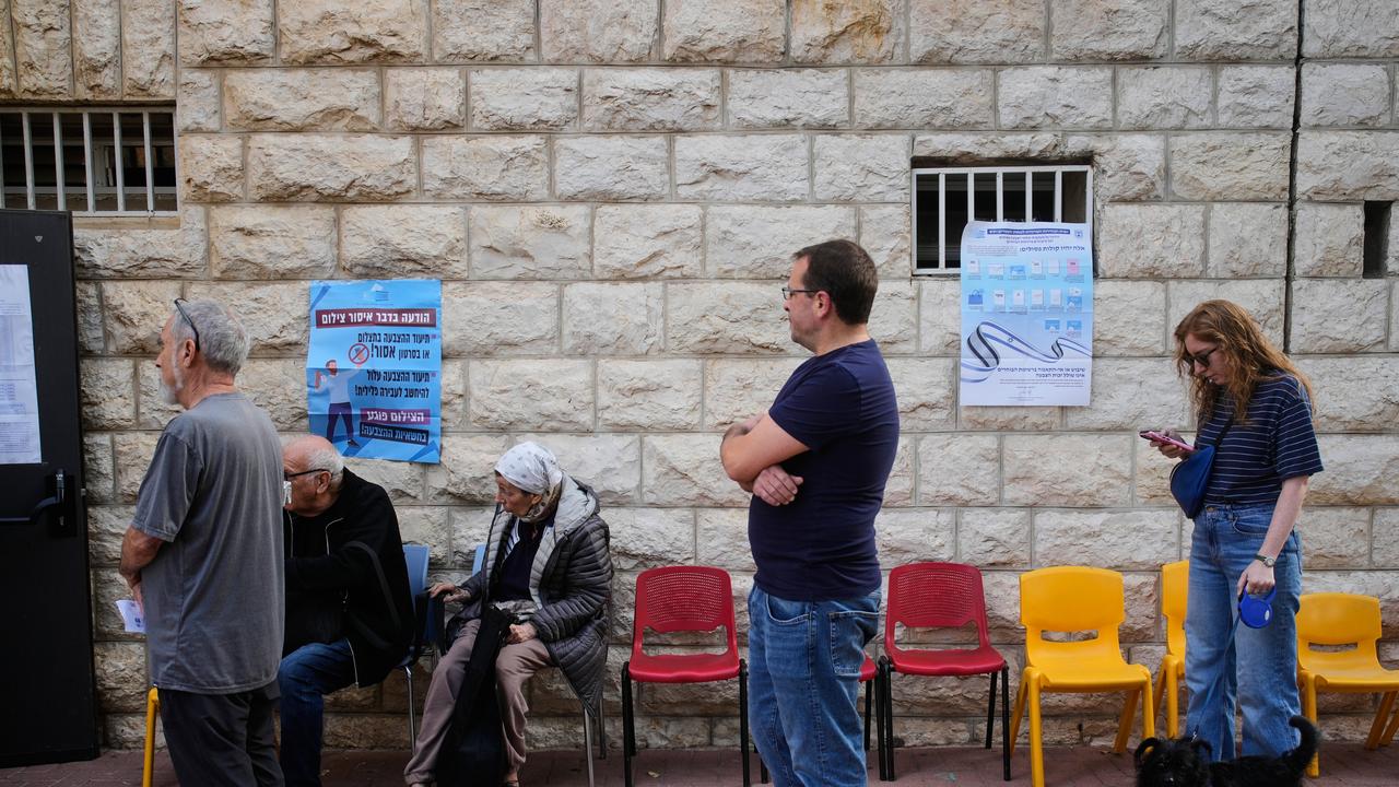 Voters line up outside a polling site.