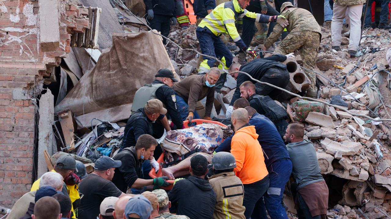 Rescuers carry bodies after a Russian missile strike in Pryluky