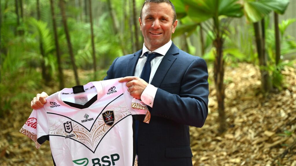 PNG Chiefs coach Willie Peters with a jersey featuring the NRL expansion club’s logo.
