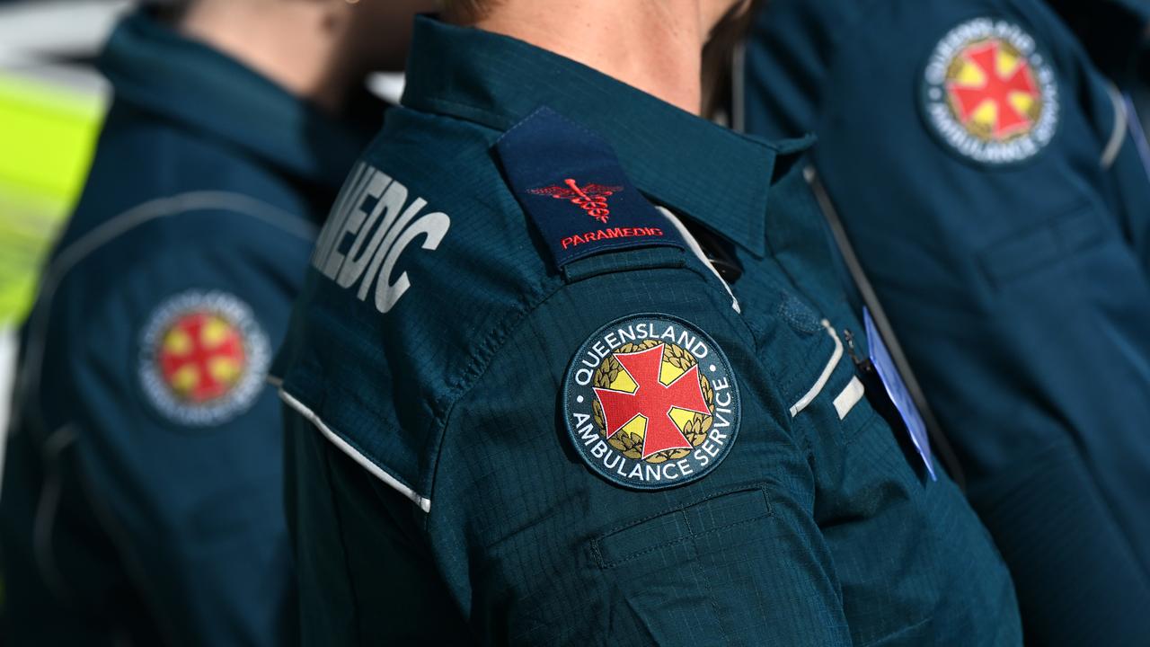 Paramedics with the logo for the Queensland Ambulance Service
