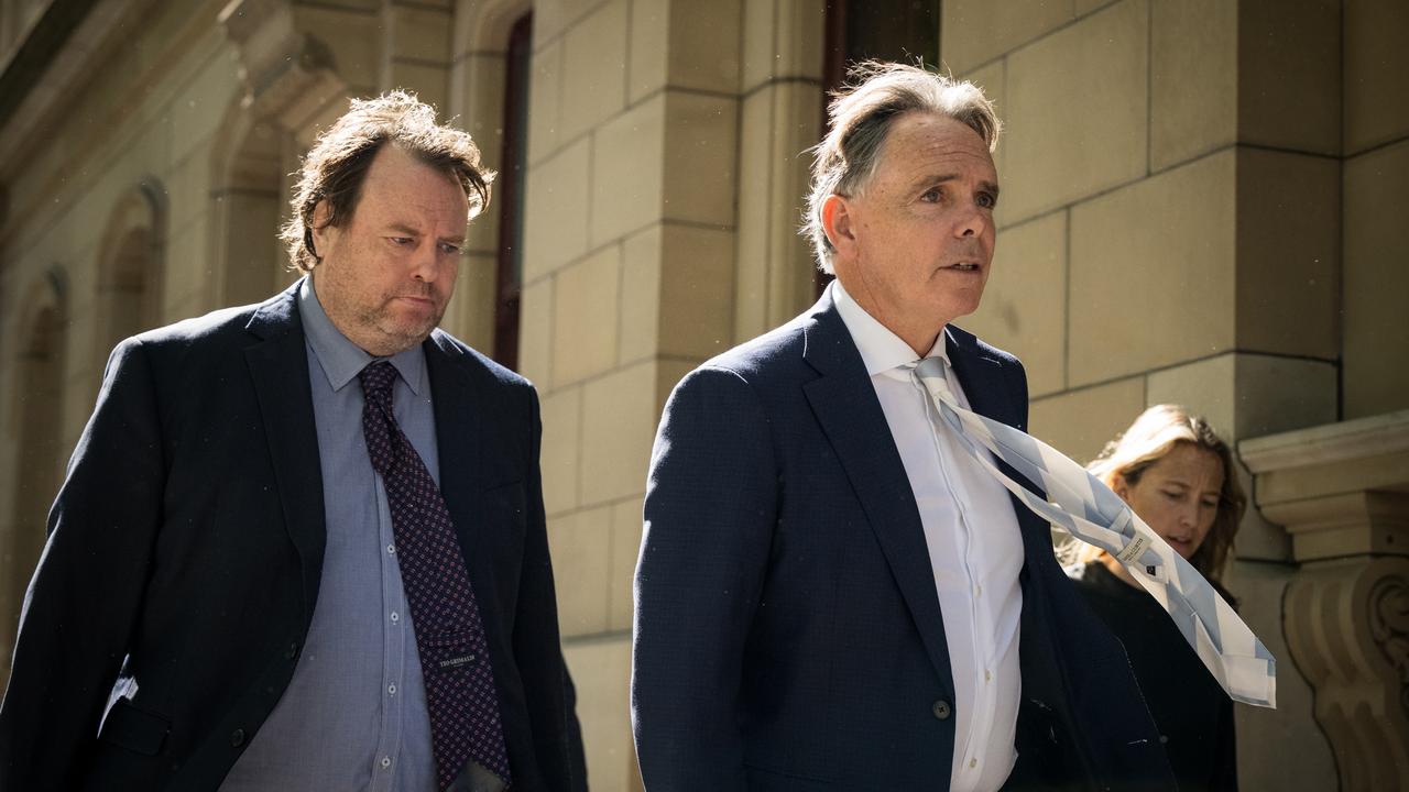 two men in suits walk to court