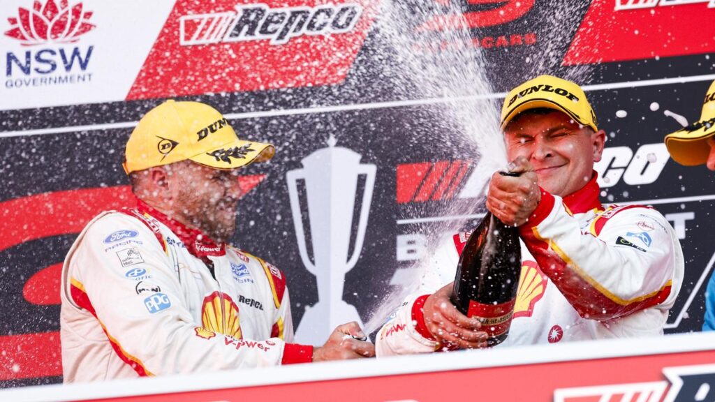 Brodie Kostecki (l) and Todd Hazelwood (c) celebrate their Bathurst 1000 triumph.
